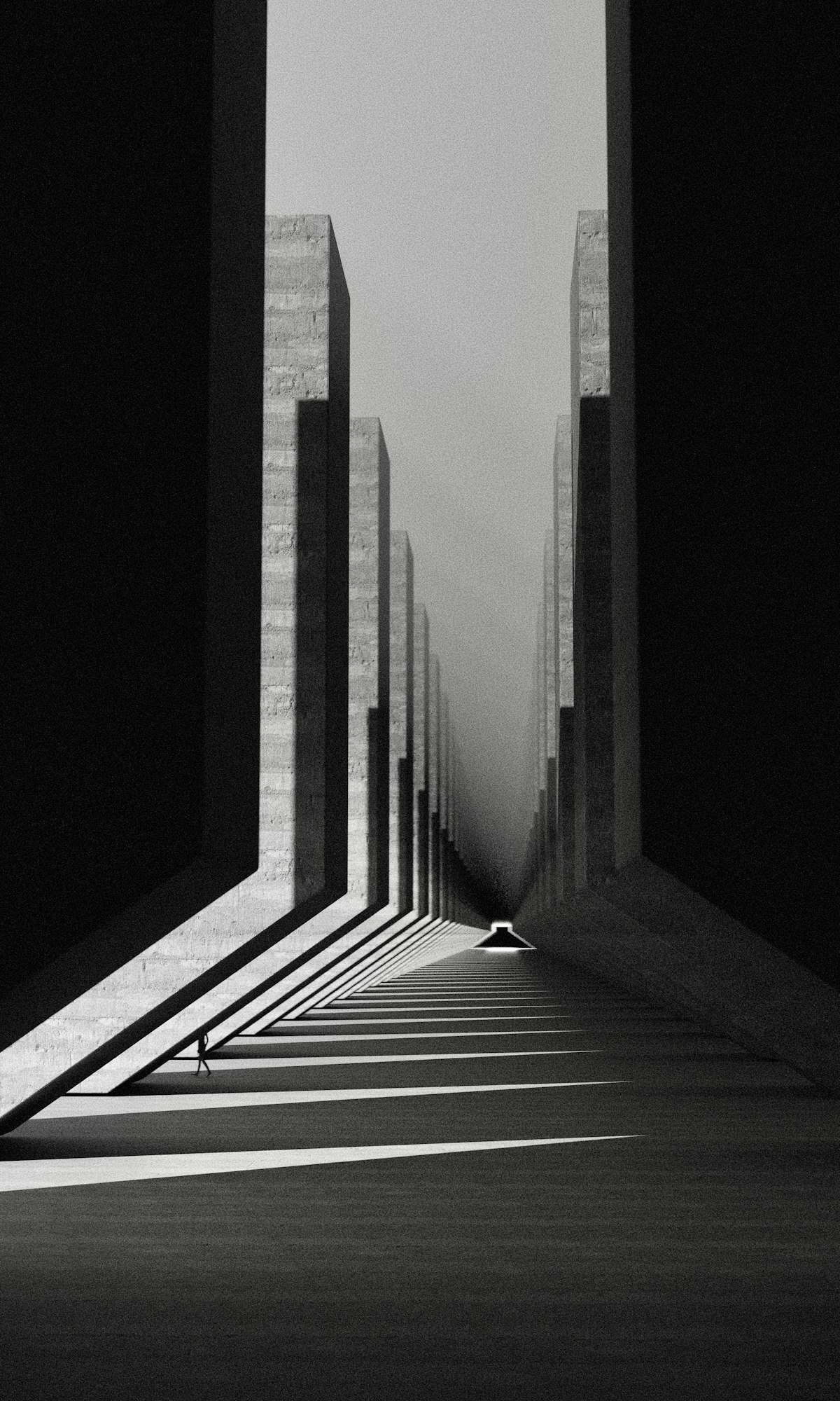 Black and white photograph of a long covered concrete walkway, its tall fins casting stripes of daylight, with a lone figure far along it